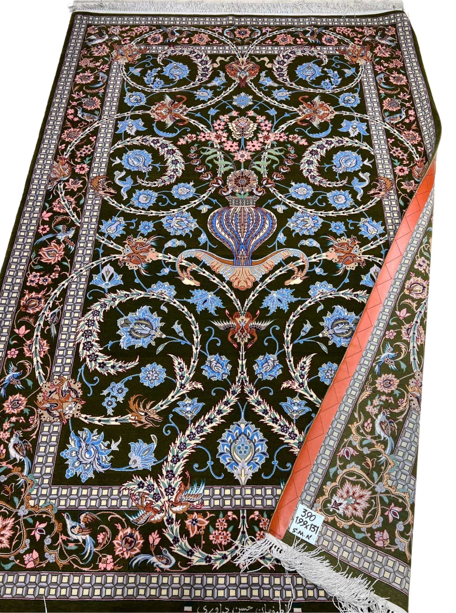 Handwoven Persian rug with intricate floral patterns.